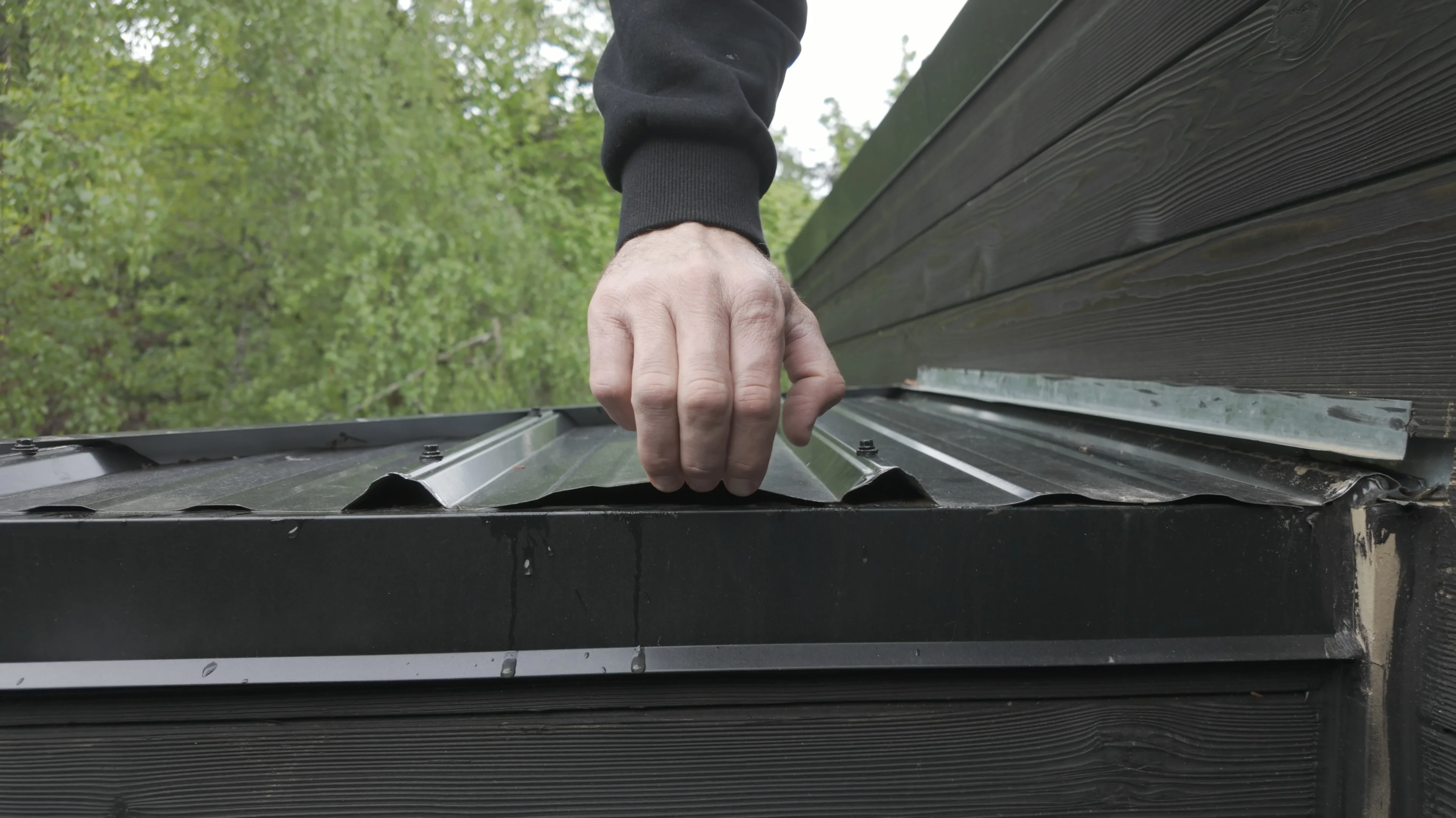 Commercial roofing technician inspecting a low-slope roof surface