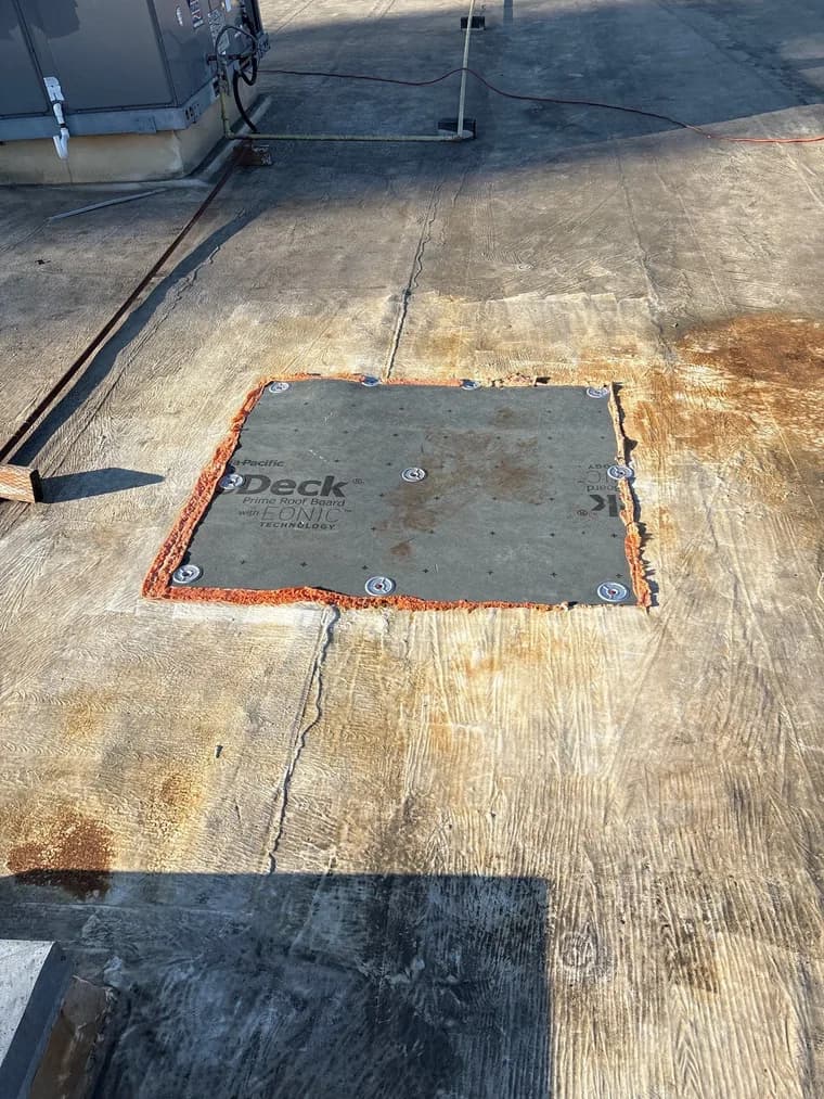 Exposed roof-deck substrate during localized rebuild and preparation work